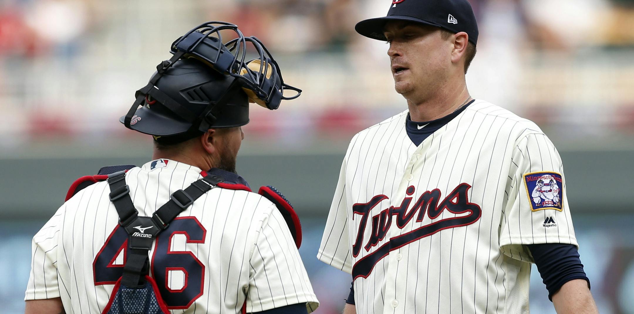 Minnesota Twins' Bobby Wilson, left, has a chat at the mound with pitcher Kyle Gibson after he gave up a walk to Los Angeles Angels' Justin Upton in the third inning of a baseball game Saturday, June 9, 2018, in Minneapolis. (AP Photo/Jim Mone)