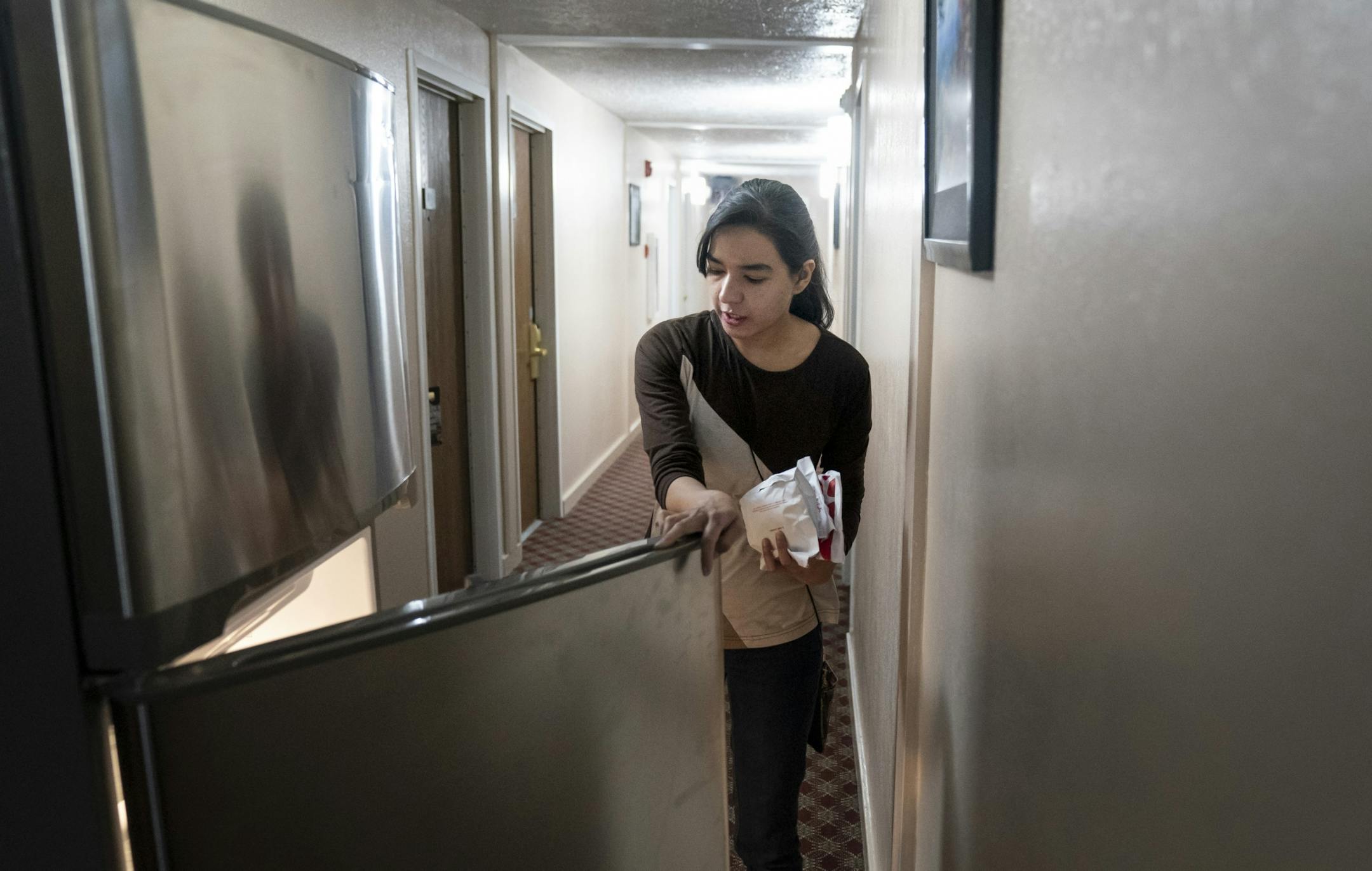 Chaska Super 8 general manager Sana Cheema moved a fridge into the hallway of the hotel to accommodate residents. The hotel has been sheltering homeless people since December. Photographed in Chaska, Minn., on Friday, May 15, 2020.