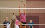 Alli Ahlers jumped up to block a spike during Denfeld High School girl's volleyball practice in Lincoln Park Middle School on Tuesday. Girl's volleyba