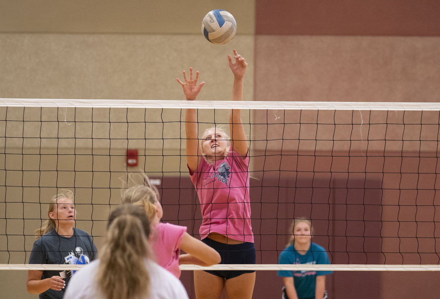 Alli Ahlers jumped up to block a spike during Denfeld High School girl's volleyball practice in Lincoln Park Middle School on Tuesday. Girl's volleyball has been moved to the spring for the 2020-21 school year. ] ALEX KORMANN • alex.kormann@startribune.com The Minnesota State High School League is voting on the fate of all fall sports on August 4, 2020. Different teams from Denfeld High School in Duluth practiced that day without knowing the fate of their sport.