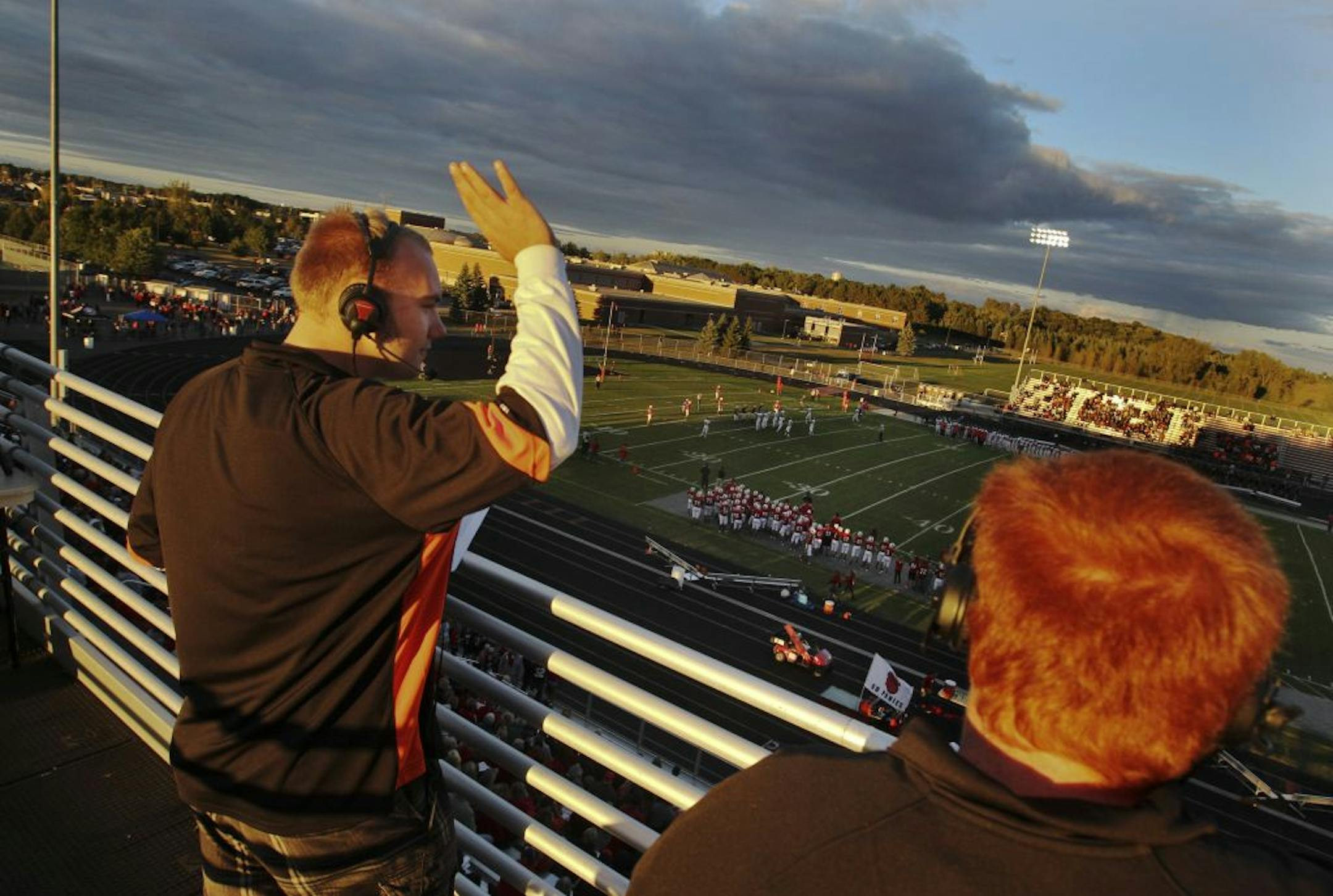White Bear Lake High School students Zach Halverson, left, and Chad Olson, right, broadcast their team's game with Stillwater High Friday, Sept. 7, 2012, at Stillwater High in Oak Park Heights, MN.