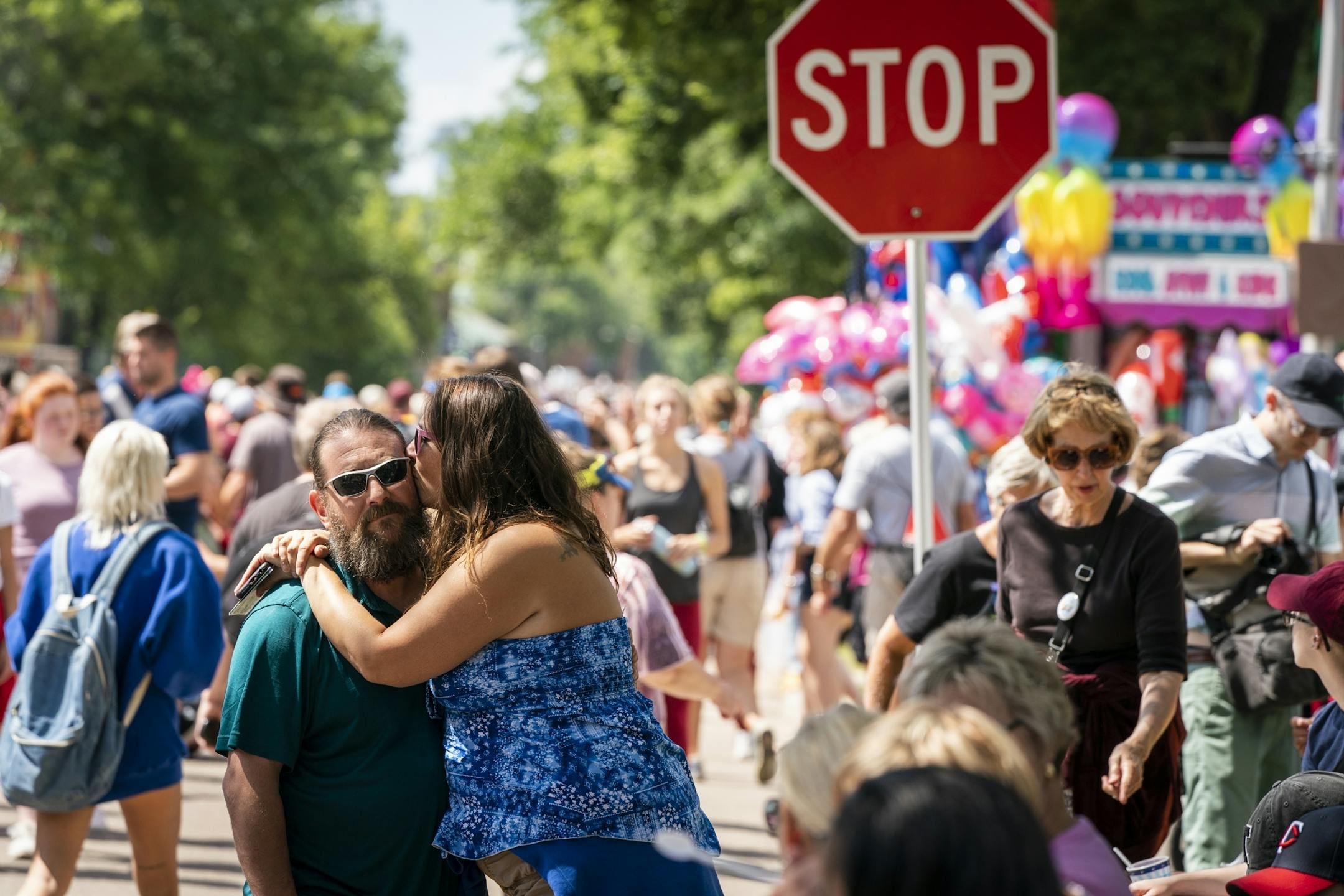 Miranda Groth and Bryan Koll, both of Apple Valley, shared a moment while waiting for the daily parade to begin Thursday.