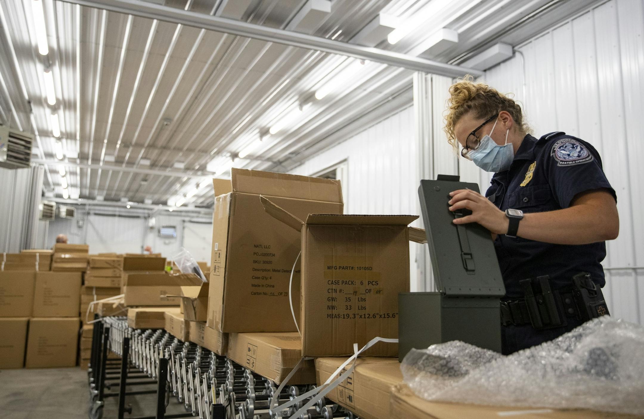 A U.S. Customs and Border Protection officer searched boxes originating from the Pacific Rim for potential intellectual property rights violations on Thursday.