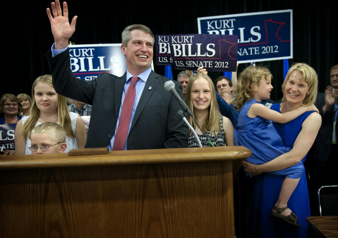 Surrounded by his family Kurt Bills waved to the crowd after being announced as the resounding winner of the GOP endorsement for U.S. Senate at the Minnesota GOP Convention in the St. Cloud Convention Center, Friday, May 18, 2012. L to R are Hayden, 7, Cassie, 12, Kyla, 15, Olivia, 5 and wife Cindy.