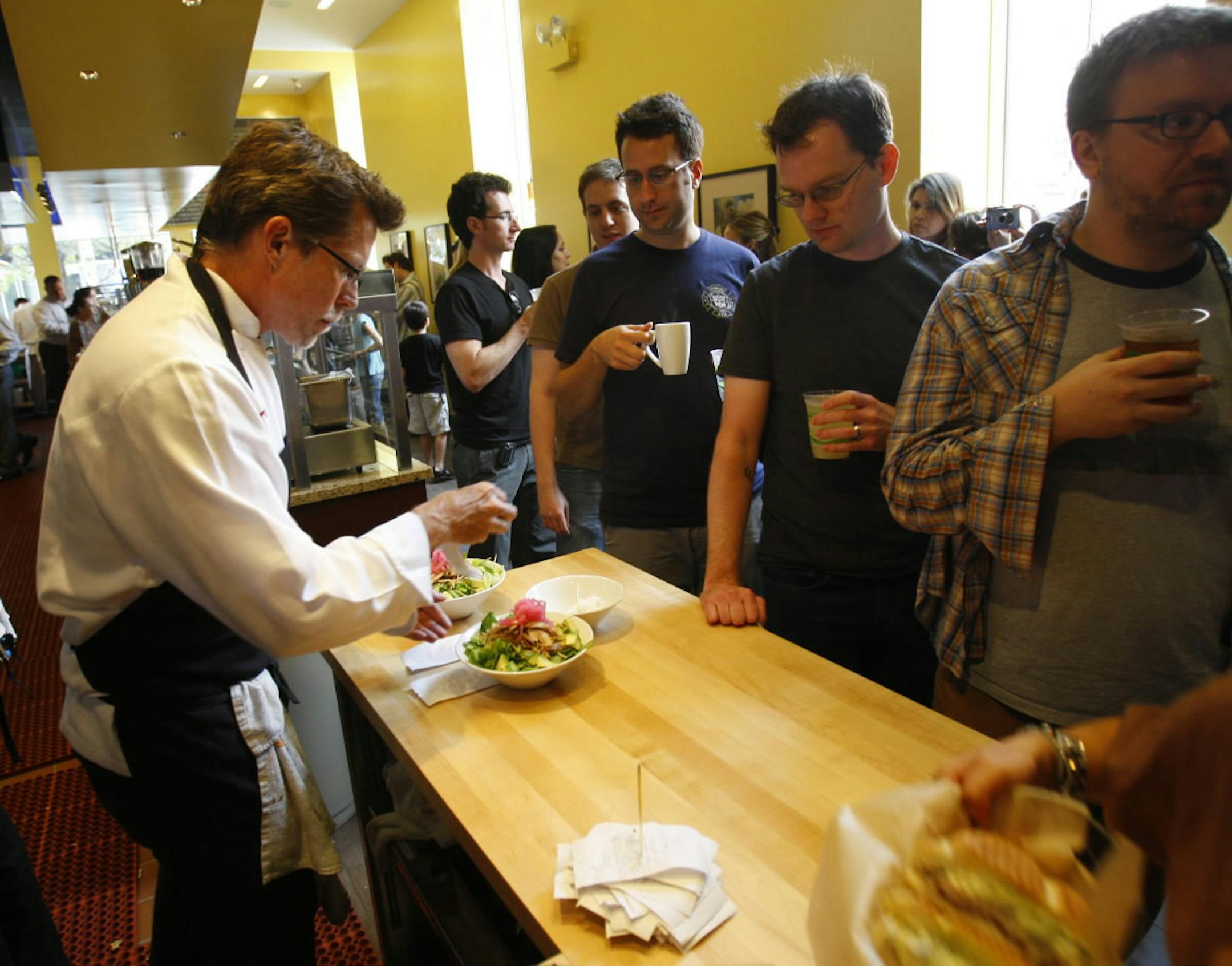 Chef Rick Bayless prepares another dish at the opening of Xoco, his new restaurant of Mexican street food, Tuesday, September 8 2009. He is planning on being at the restaurant the first week to keep things running smoothly. (Alex Garcia/Chicago Tribune) ..OUTSIDE TRIBUNE CO.- NO MAGS, NO SALES, NO INTERNET, NO TV, CHICAGO OUT.. 00310797A xoco ORG XMIT: CHI0909081651060288