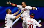 Cleveland's Jason Kipnis, center, celebrated with Mike Napoli, left, and Tyler Naquin after hitting the winning single in the 10th inning against the 