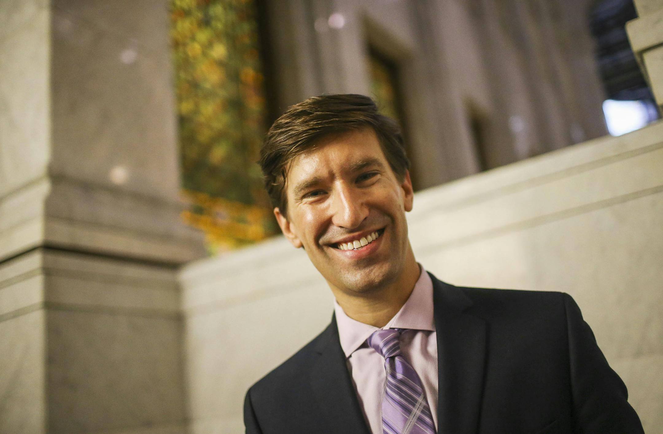Minneapolis' new city coordinator, Spencer Cronk, enjoys his new home in Minneapolis City Hall. He was recently photographed on the steps near the rotunda