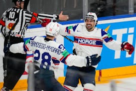 Michael Brandsegg-Nygård celebrates with Wild winger Mats Zuccarello as the two played for Norway at the world hockey championships in May.