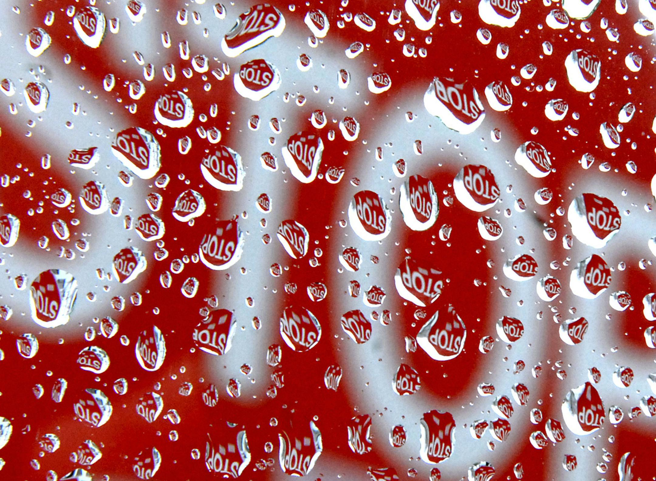 Raindrops on a car window reflect a stop sign in Lowell, Mass., Thursday morning March 20, 2008. Heavy storms have dumped as much as a foot of rain in the Midwest and left behind more than a dozen deaths. (AP Photo/Lowell Sun/Tory Germann) ORG XMIT: MALOW101 ORG XMIT: MIN2013062816431260