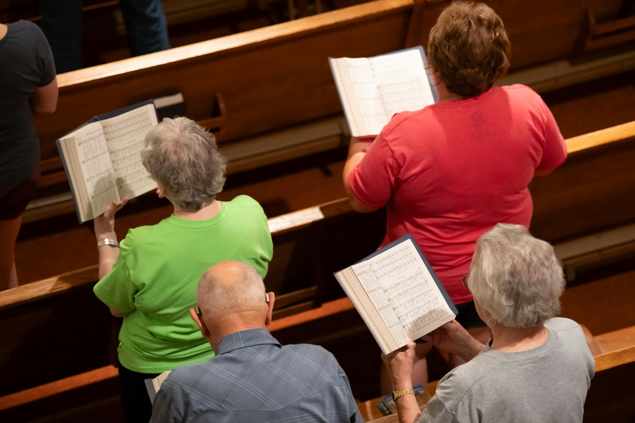Parishoners sang an opening hymn during Friday Mass at St. Joseph Church.