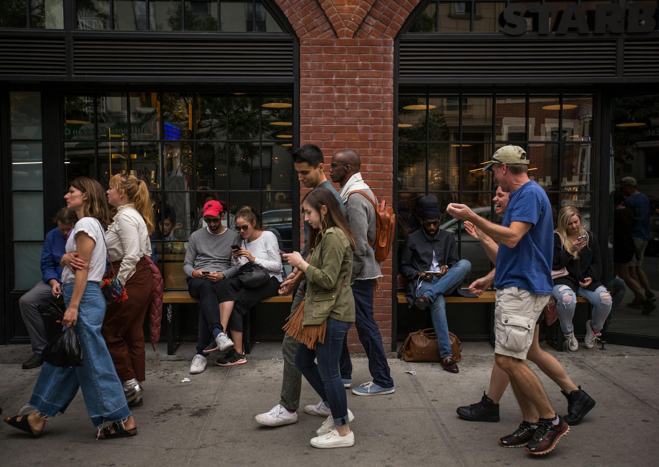 FILE ' People on smartphones in New York, Sept. 9, 2017. 'At the core of the frenzied interest in Elon Musk's acquisition of Twitter is an intuition that I think is right: The major social media platforms are, in some hard-to-define way, essential to modern life,' writes New York Times columnist Ezra Klein. (Ali Asaei/The New York Times)
