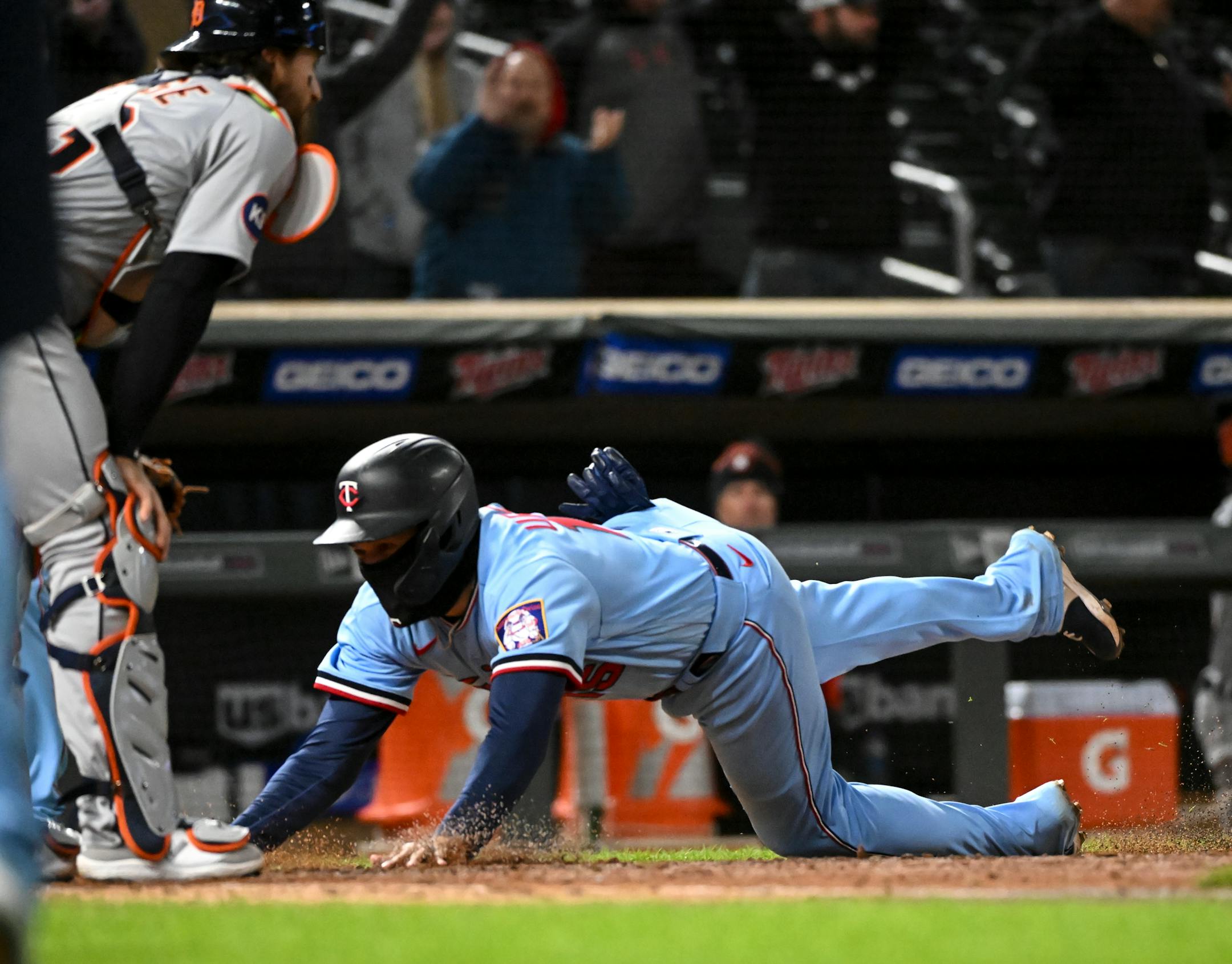 Minnesota Twins third baseman Gio Urshela (15) slides home for the game-winning run off a throwing error by Detroit Tigers catcher hitter Eric Haase (13).