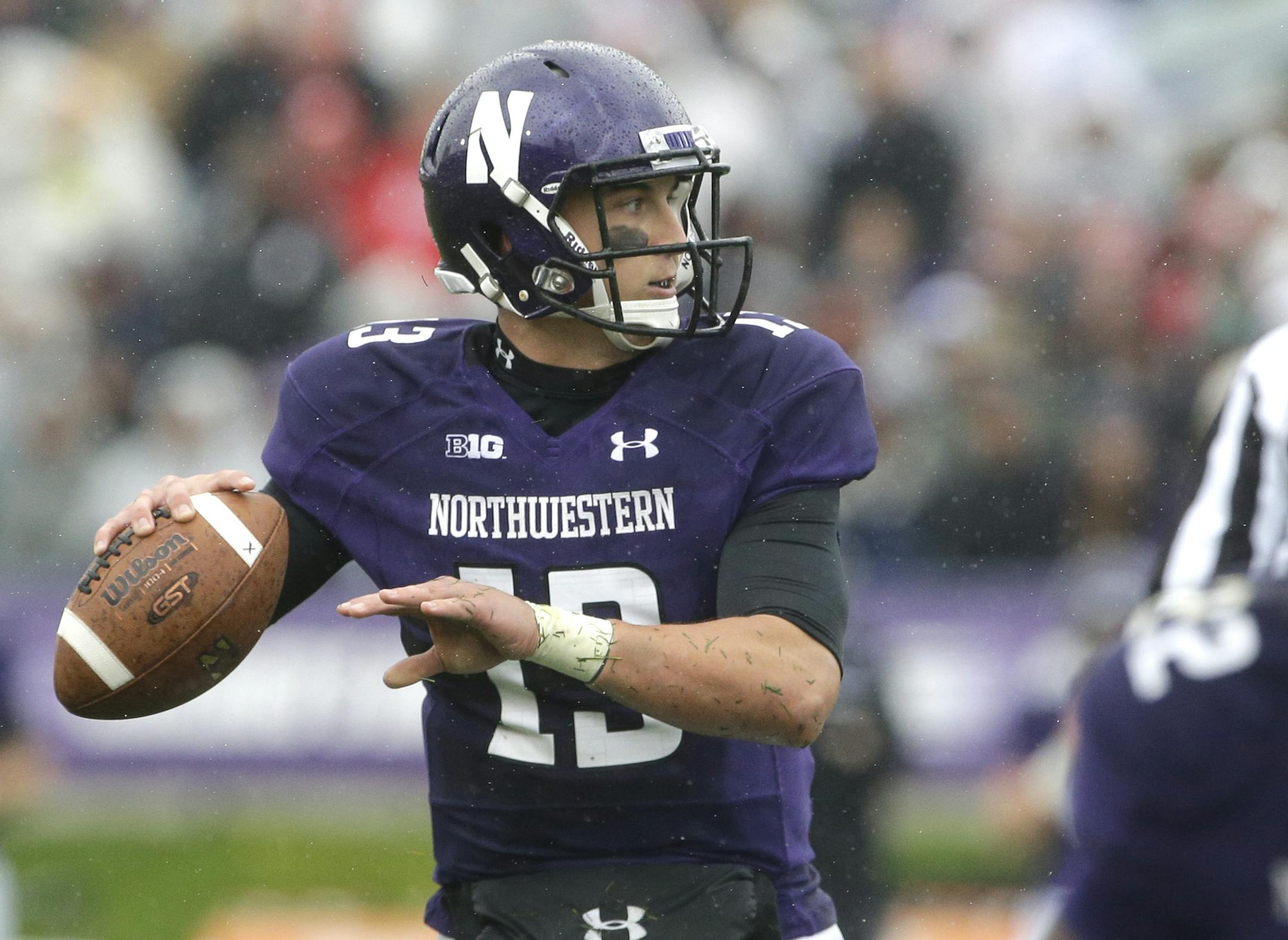 Northwestern quarterback Trevor Siemian (13), left, looks to a pass against Wisconsin during the first half of an NCAA college football game in Evanston, Ill., Saturday, Oct. 4, 2014. (AP Photo/Nam Y. Huh) ORG XMIT: MIN2014100918505670