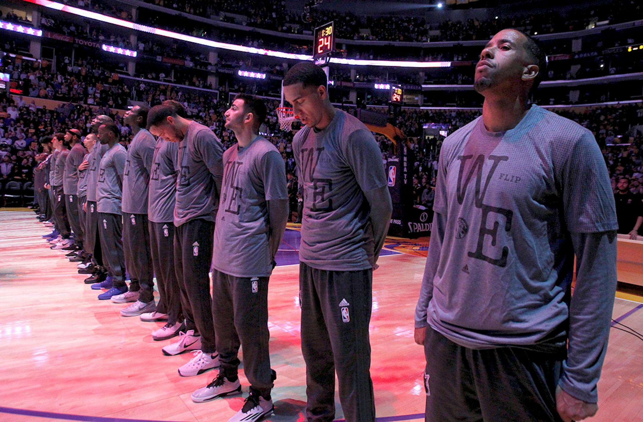 Minnesota Timberwolves stand in dedication to Flip Saunders during warmups before an NBA basketball game against the Los Angeles Lakers in Los Angeles, Wednesday, Oct. 28, 2015.