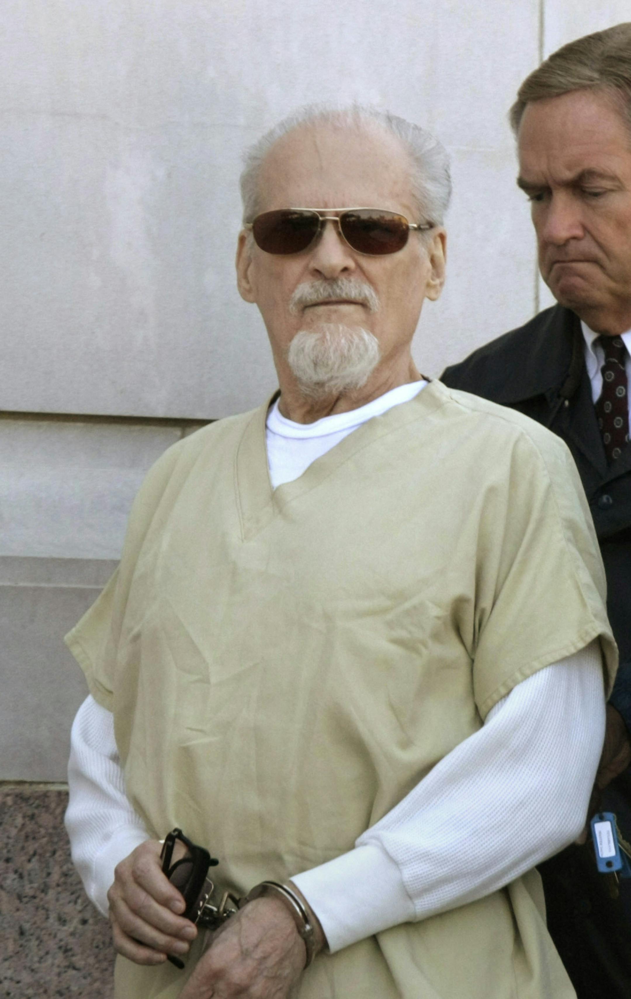 Evangelist Tony Alamo, left, is escorted from the Federal Court House in Texarkana, Ark., after a day of jury deliberations in his trial Thursday, July 23, 2009. (AP Photo/Danny Johnston)