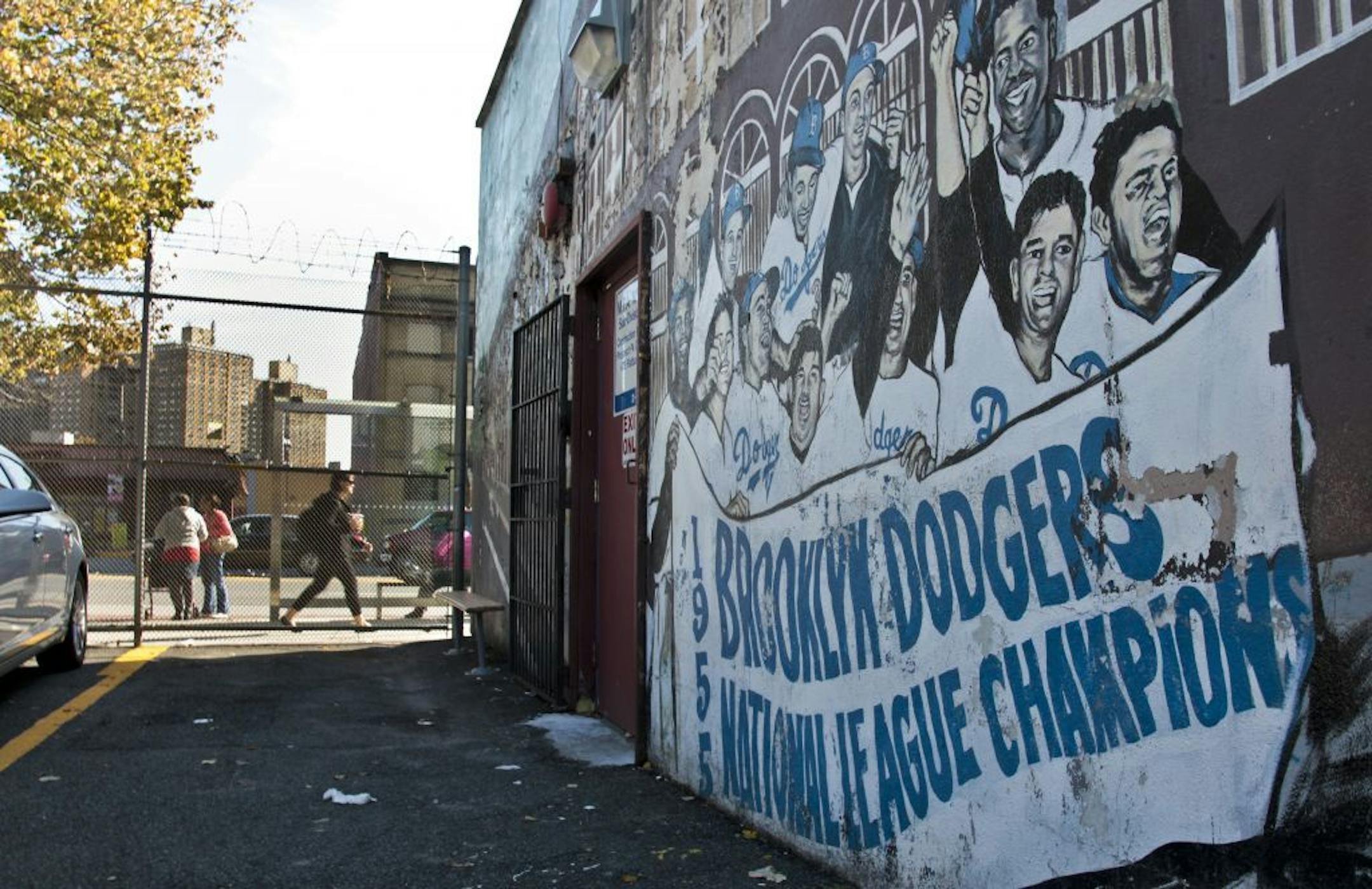A mural recalling the Brooklyn Dodgers baseball team, shows signs of decay on the wall of a subway station on Wednesday, Sept. 19, 2012 in Brooklyn, N.Y. The mural is a short walk from Ebbets Field, where the Dodgers played and now a sprawling apartment complex to thousands after the team moved west decades ago. Now Brooklyn is back in the professional leagues again with a new arena and the Brooklyn Nets' NBA franchise.
