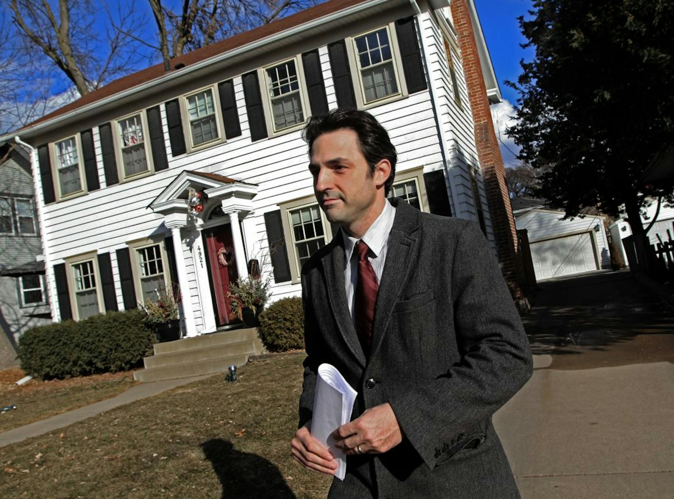 Real Estate Agent Graham Smith walked back to his car after showing a south Minneapolis home to a client on 2/16/12. The home wasn't listed anymore, but Smith combs expired and canceled listings in the search of something that might work for a client.
