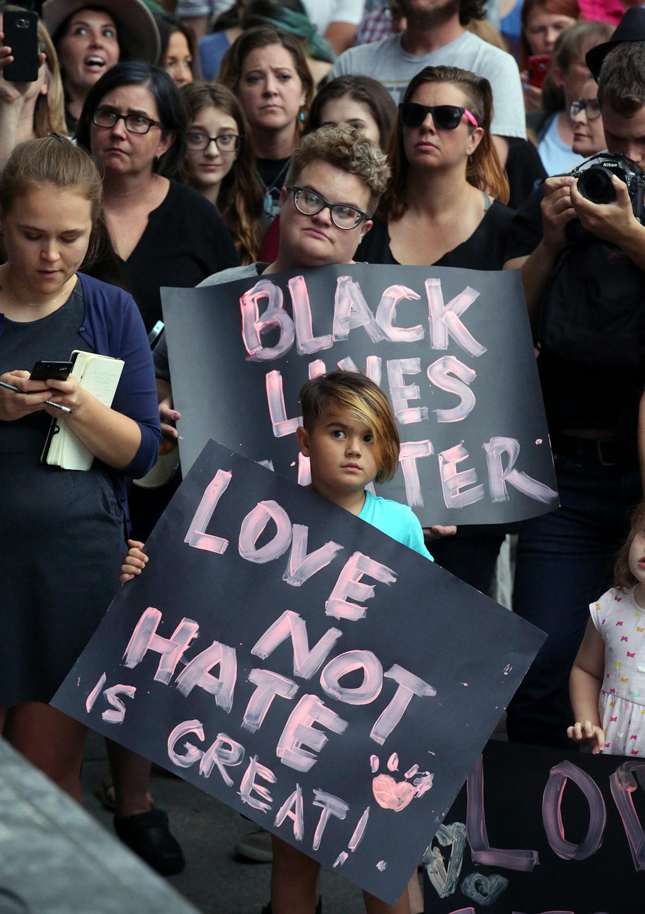 People gather for a rally Monday, Aug. 14, 2017, in Salt Lake City. Utah residents held a unity and anti-racism rally Monday night to denounce the messages of hate and violence of white supremacists at a weekend rally in Charlottesville, Virginia.