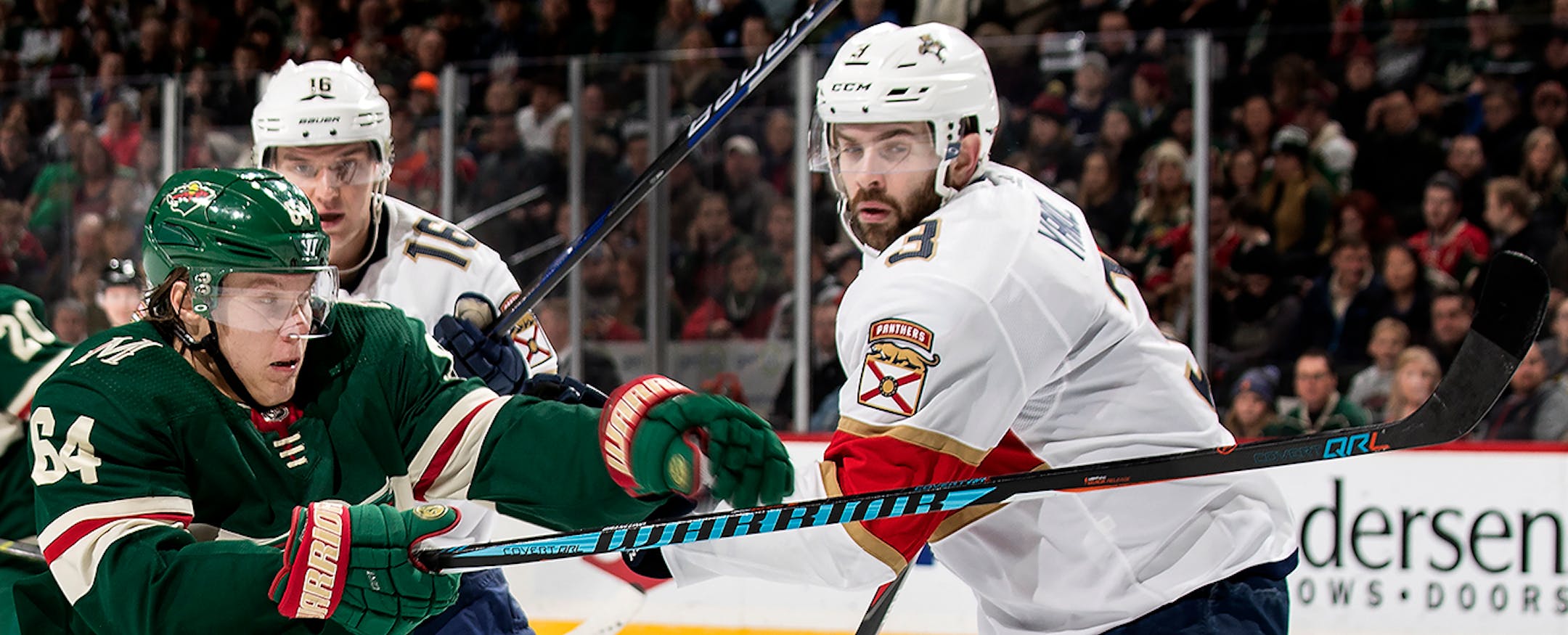 Mikael Granlund (64) and Keith Yandle (3) in the first period.