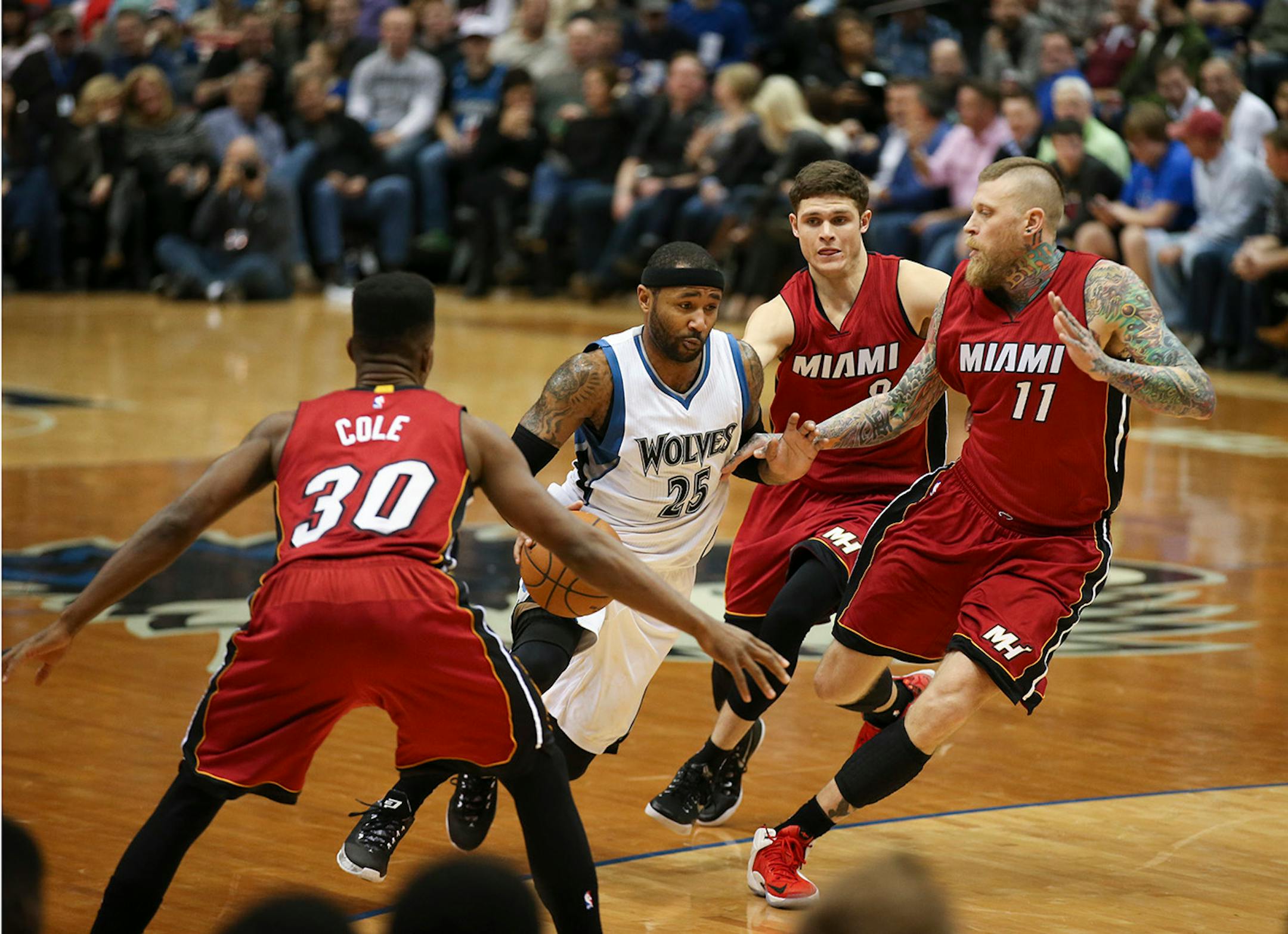 Timberwolves guard Mo Williams moved the ball up court against the defense of, from left, Miami Heat guard Norris Cole, guard Tyler Johnson, and forward Chris Andersen in the third quarter Wednesday night at Target Center.