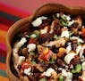 Black beans and black rice combine in a main dish that also packs in poblanos, corn, red peppers, queso fresco and more.