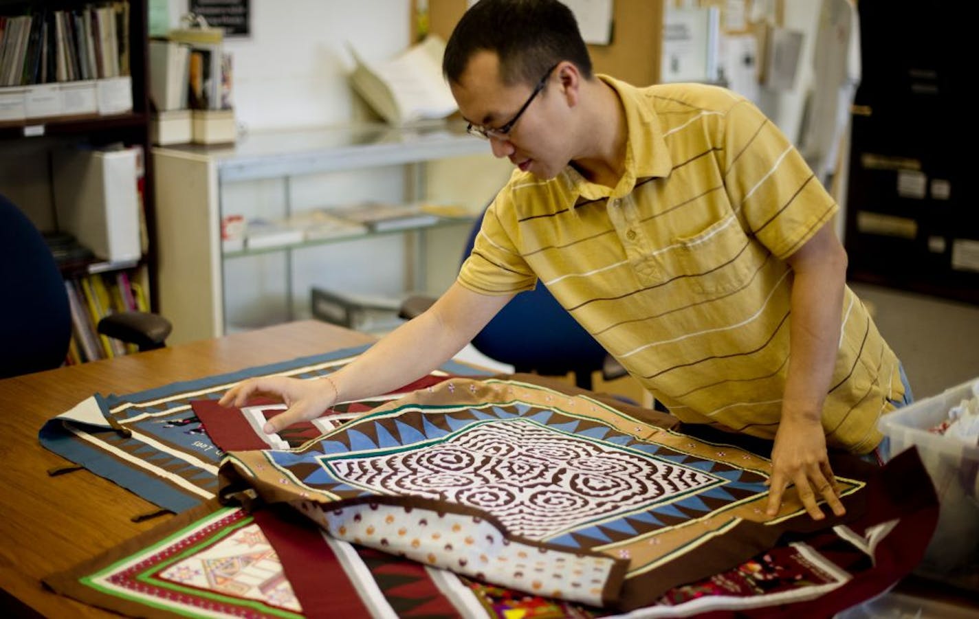 Xai Lor, curator at the Hmong Cultural Center started a website to catalog the meanings traditional Hmong quilts. Wednesday, November 21, 2012.