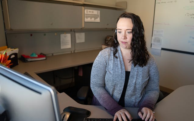 Alyssa Raway, a child & family intake social worker, completes a child protection intake for screening using the social services information system at