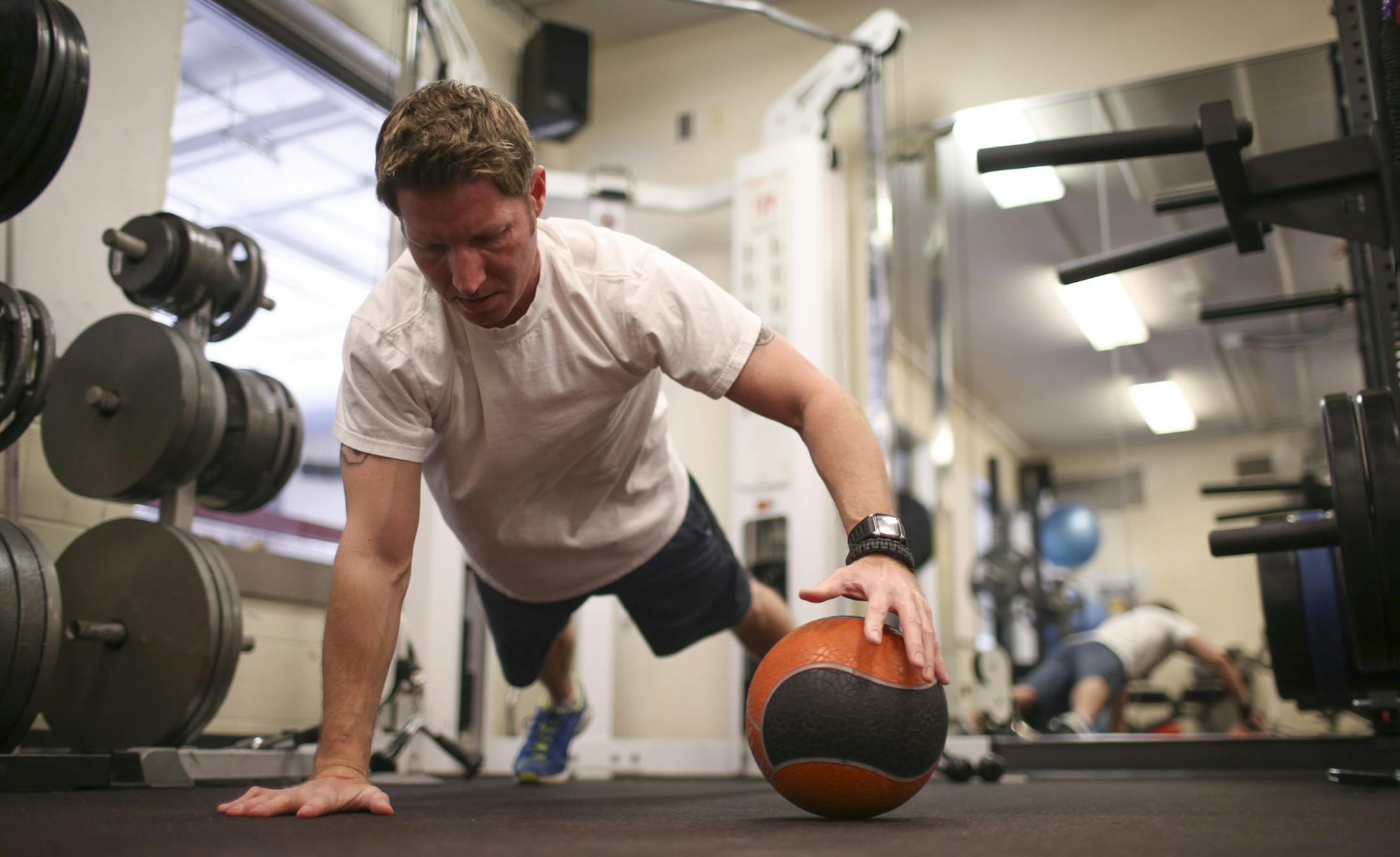 Tyler Rishavy did pushups in the weight room at the fire station Tuesday afternoon. He works for the Hopkins Police Department in parking enforcement. ] JEFF WHEELER • jeff.wheeler@startribune.com More west metro suburban police departments are starting fitness initiatives for their officers to stay fit, part of a Minnesota-wide trend toward voluntary wellness programs for police officers to combat the high-stress, yet often sedentary, job. In Hopkins, members of the police department wor