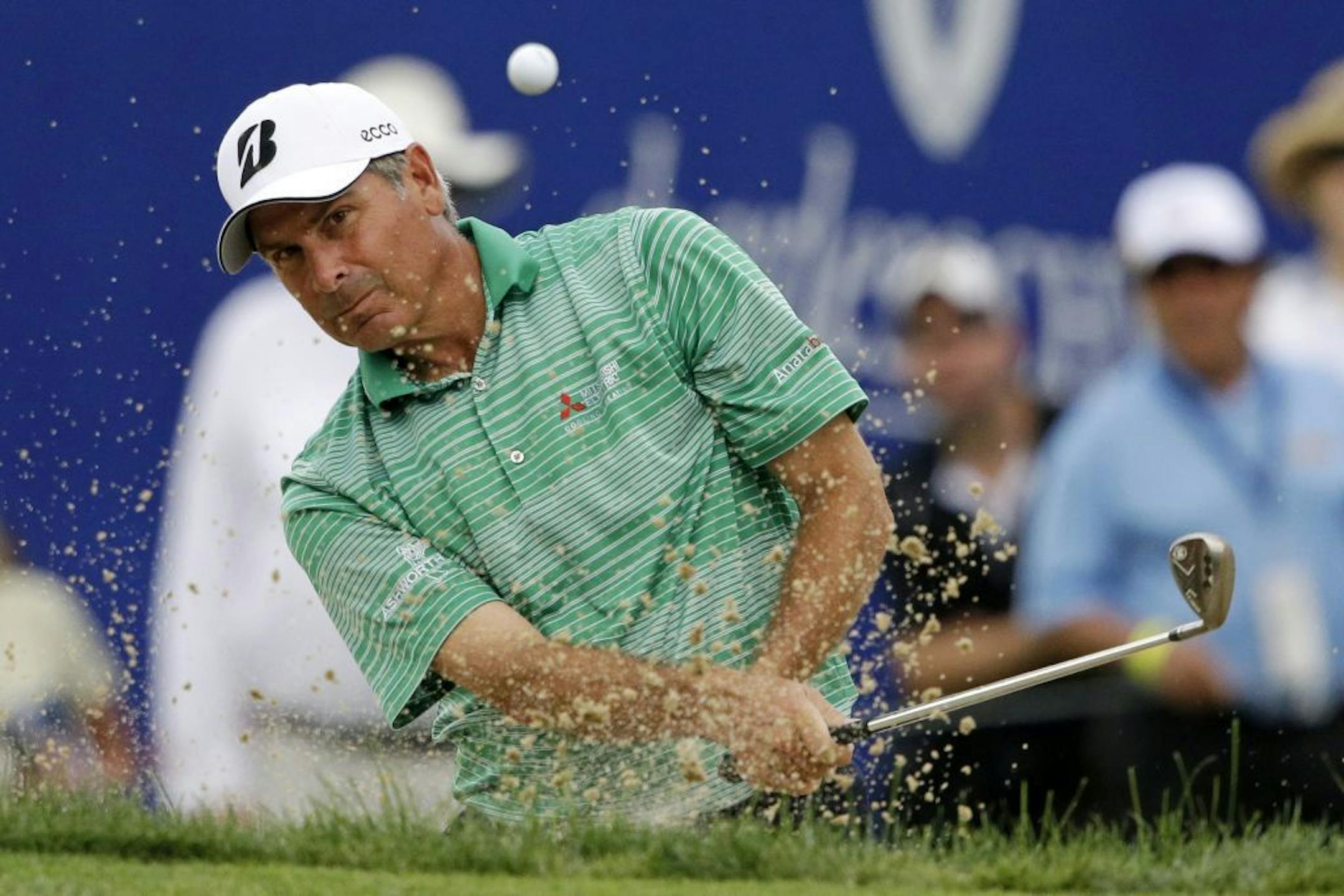 Fred Couples hits out of a bunker on the 18th green during the second round of the Senior Players Championship golf tournament at Fox Chapel Golf Club in Pittsburgh, Friday, June 28, 2013.