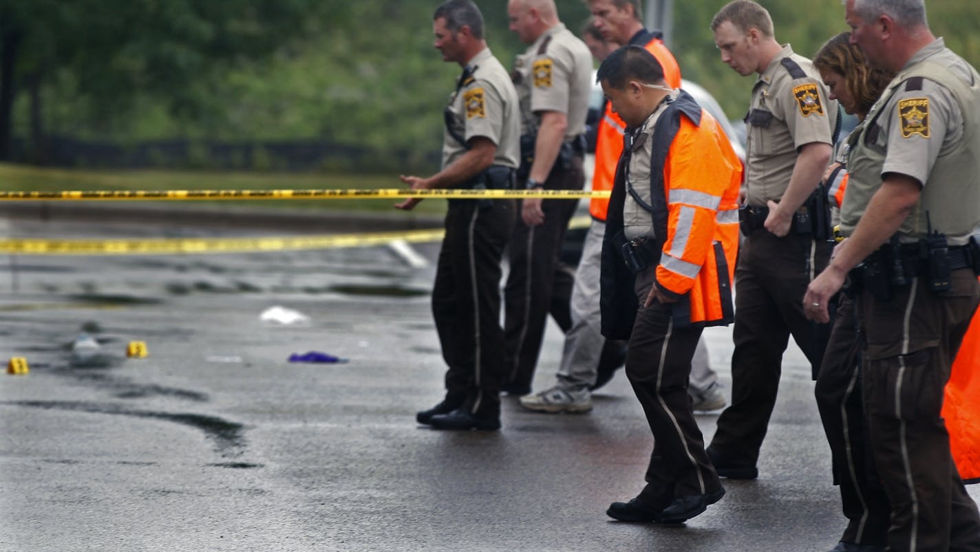 At the Holiday gas startion on Hwy. 96 near the the 35W exit in Arden Hills on Aug. 11, 2104, investigators examined the evidence at the site of a fatal shooting.