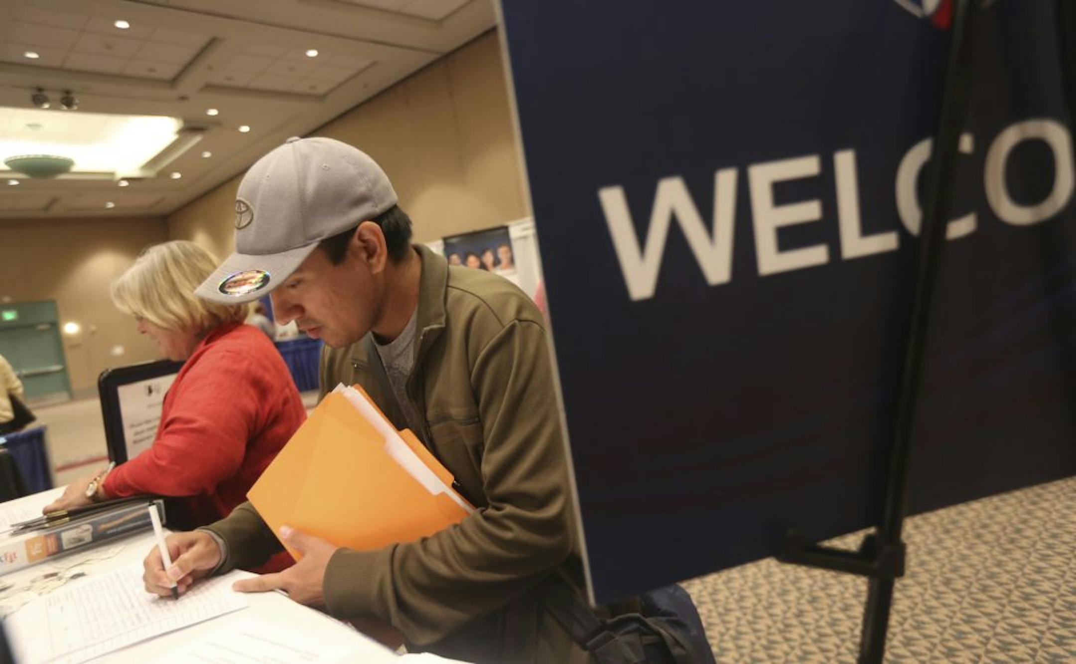 Miguel Bobadilla filled out employment information during an NAACP job fair in Minneapolis last month.