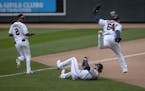 Minnesota Twins catcher Willians Astudillo (64) jumped over teammate right fielder Jake Cave (60) after he caught a foul ball hit by Pittsburgh Pirate