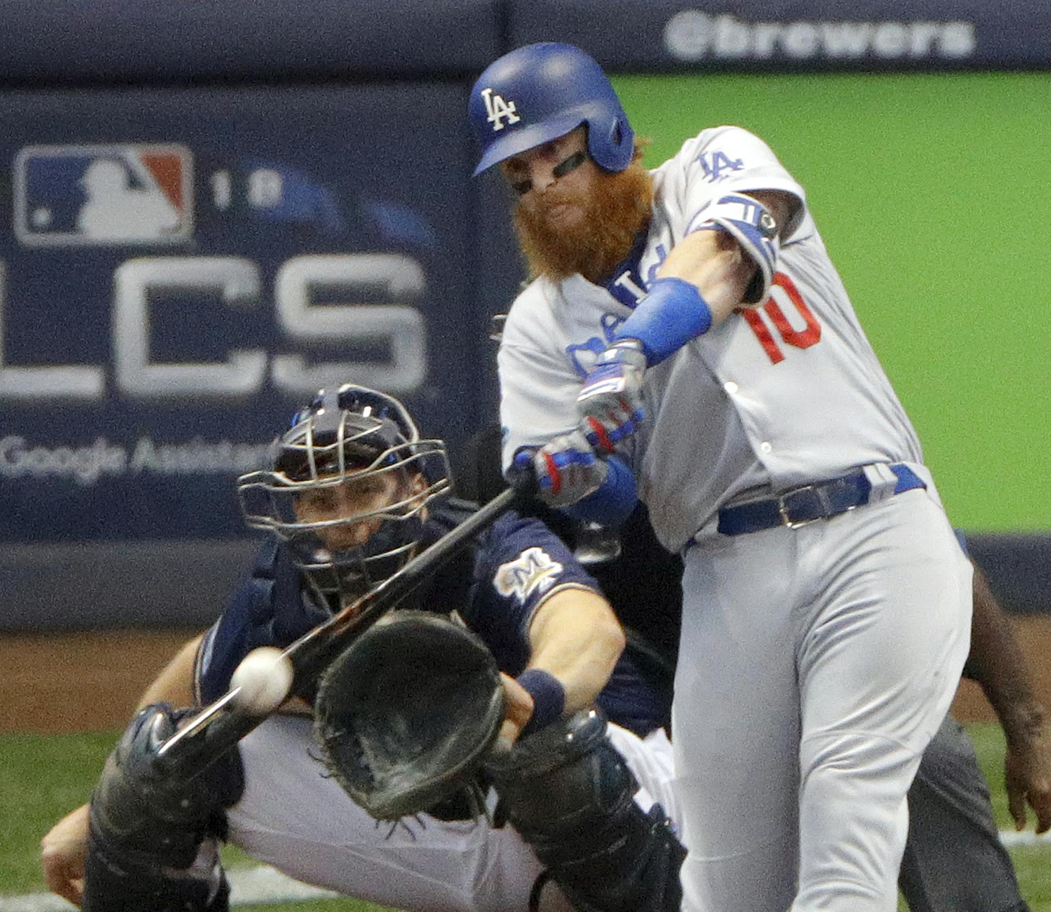 Los Angeles Dodgers' Justin Turner (10) hits a two-run home run during the eighth inning of Game 2 of the National League Championship Series baseball game against the Milwaukee Brewers Saturday, Oct. 13, 2018, in Milwaukee. (AP Photo/Charlie Riedel)