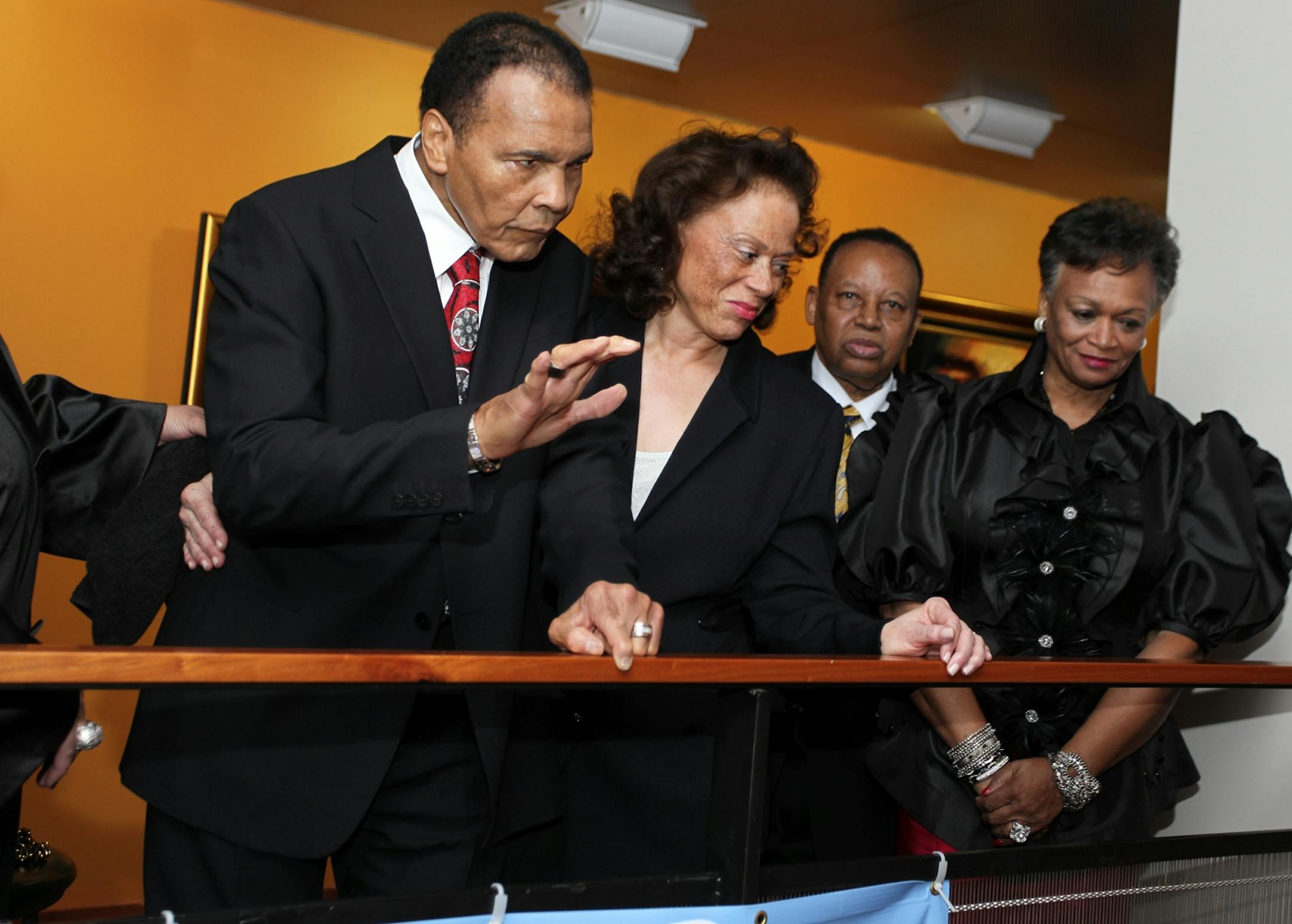 Muhammad Ali., left, welcomes his guests along with his wife Lonnie Ali, center, at a fund raiser for the Muhammad Ali Center in his hometown of Louisville, Ky., on Saturday, Jan. 14, 2012. Ali turns 70 Tuesday.