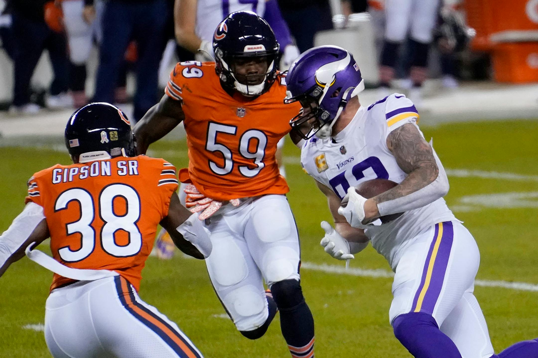 Minnesota Vikings tight end Kyle Rudolph, right, runs with the ball before fumbling for a turnover as Chicago Bears linebacker Danny Trevathan (59) and safety Tashaun Gipson Sr. (38) defend during the first half of an NFL football game Monday, Nov. 16, 2020, in Chicago. The Bears recovered the fumble. (AP Photo/Charles Rex Arbogast)