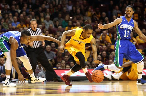 FILE -- Gophers DeAndre Mathieu stole the ball away from TAMCC's Jeff Beverly during the first half at Williams Arena in Minneapolis Saturday, Decembe