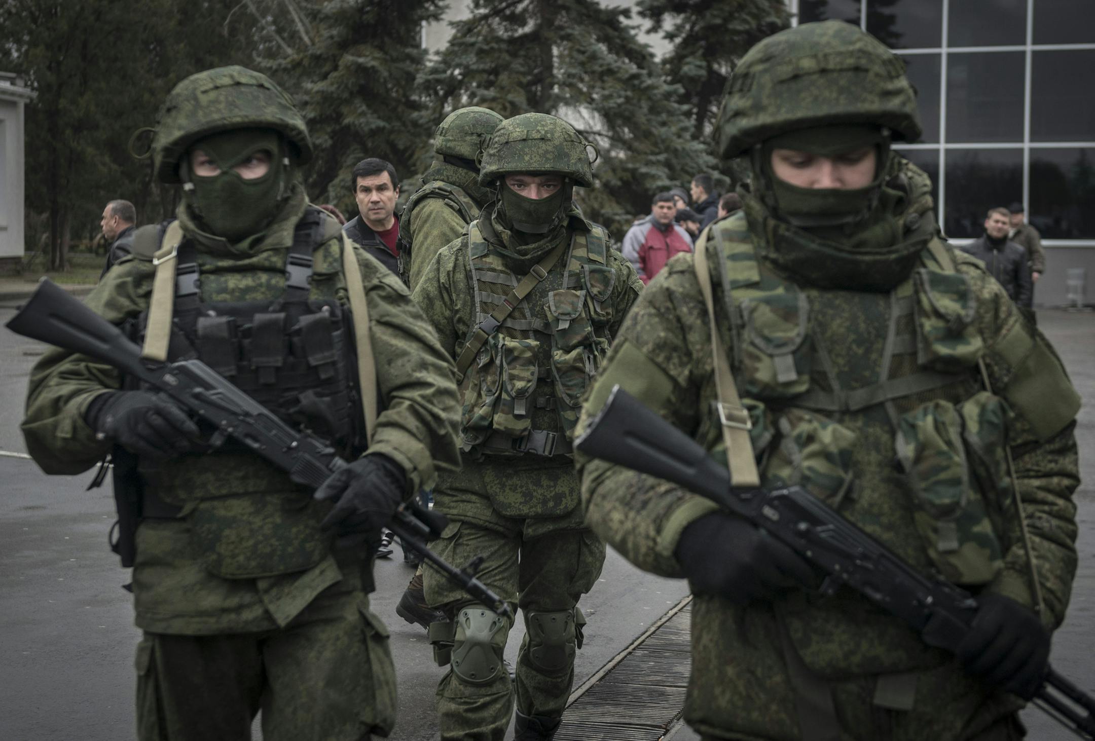 Armed men patrol the street outside Simferopol‚Äôs airport in the Crimea region of Ukraine, Feb. 28, 2014. As the possibility of a showdown between Ukraine‚Äôs fledgling government and the Kremlin appeared to grow Friday, armed men whose uniforms bore no insignia took up positions at the Simferopol and Belbek airports as Interior Minister Arsen Avakov warned of a direct provocation, but there was no sign of any violence. (Sergey Ponomarev/The New York Times)