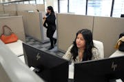 Yaneth Quintero Cruz, a program specialist at the Hennepin County Assessor's office, works from her cubical at the Hennepin County Government Center o