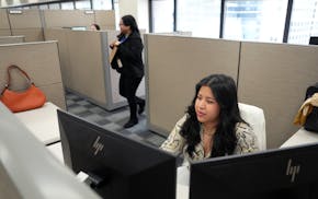 Yaneth Quintero Cruz, a program specialist at the Hennepin County Assessor's office, works from her cubical at the Hennepin County Government Center o