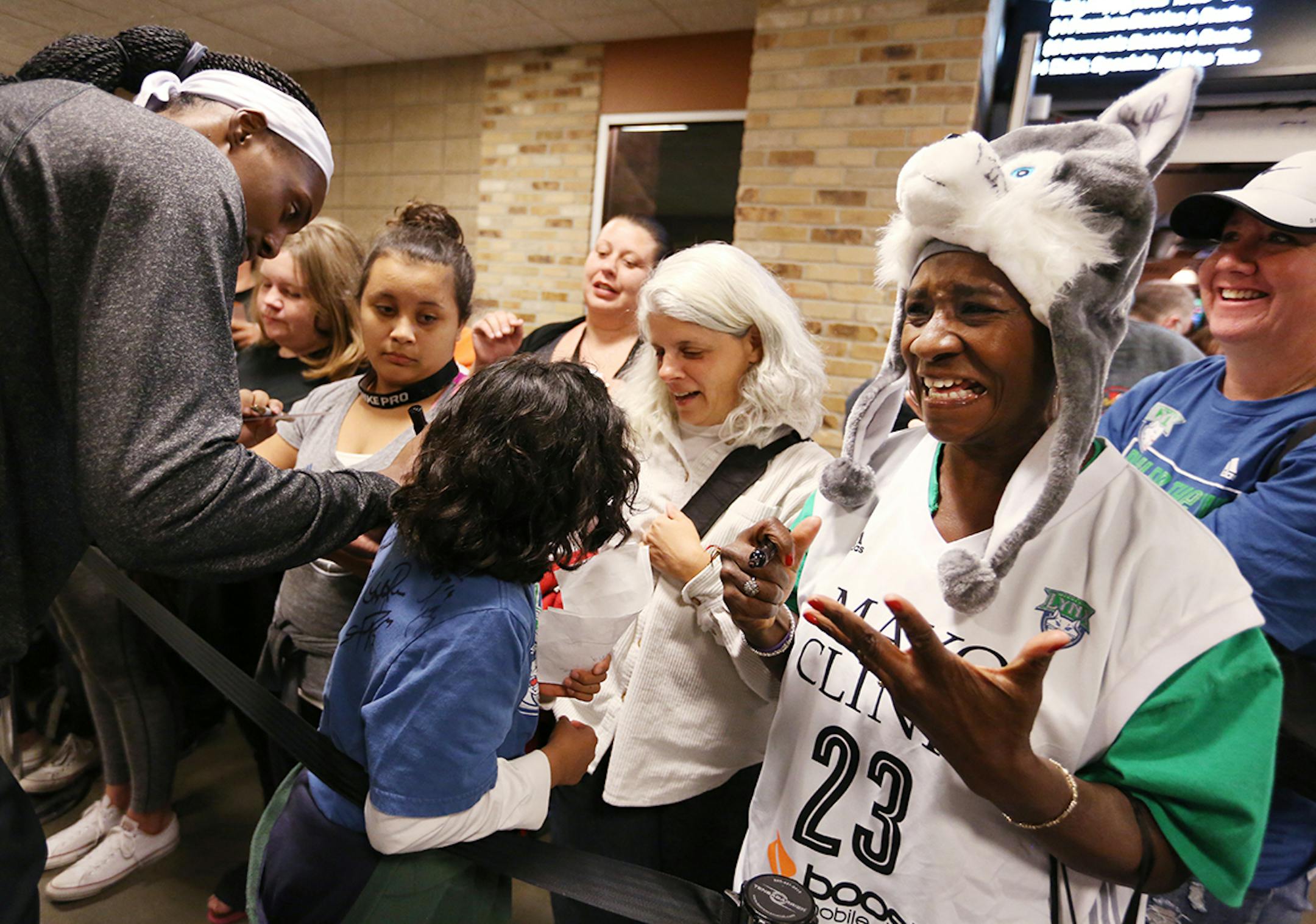 Minnesota Lynx fan Anice Miller, right, of Minneapolis expresses her excitement after getting an autograph from Minnesota Lynx center Sylvia Fowles (34) before the game.