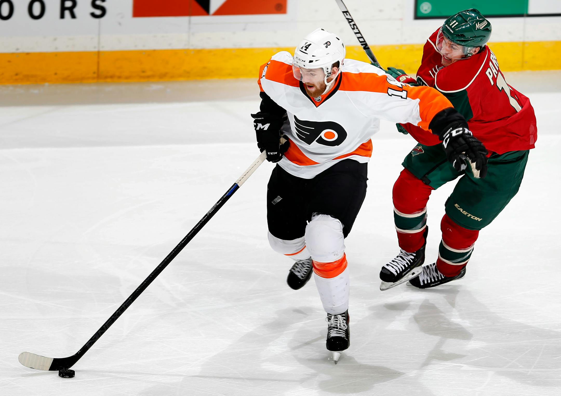 Sean Couturier (14) and Zach Parise (11) fought for the puck during a game last season.