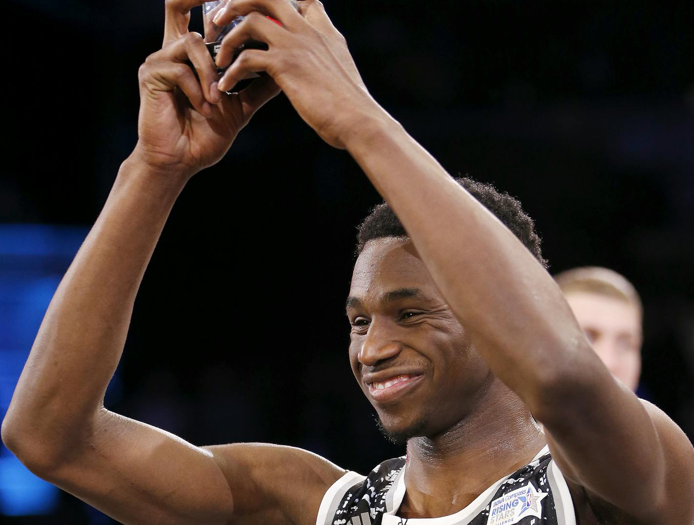 World Team's Andrew Wiggins, of the Minnesota Timberwolves, shows off his MVP trophy after NBA basketball's Rising Stars Challenge, Friday, Feb. 13, 2015, in New York. The World team defeated the U.S. team 121-112. (AP Photo/Julio Cortez)