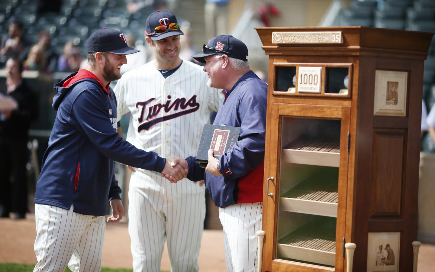 Twins players Glen Perkins, and Joe Mauer gave their congradulations to manger Ron Gardenhire right after he was giving a humidor for his 1000 wins before the game between the Minnesota Twins and Oakland A's at Target Field April 9, 2014 in Minneapolis , MN. ] JERRY HOLT jerry.holt@startribune.com