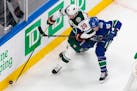 Wild defenseman Ryan Suter (stickhandling past Vancouver's Jay Beagle) played a team-high 23 minutes, 36 seconds against the Canucks in Game 1 on Sund