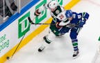 Wild defenseman Ryan Suter (stickhandling past Vancouver's Jay Beagle) played a team-high 23 minutes, 36 seconds against the Canucks in Game 1 on Sund