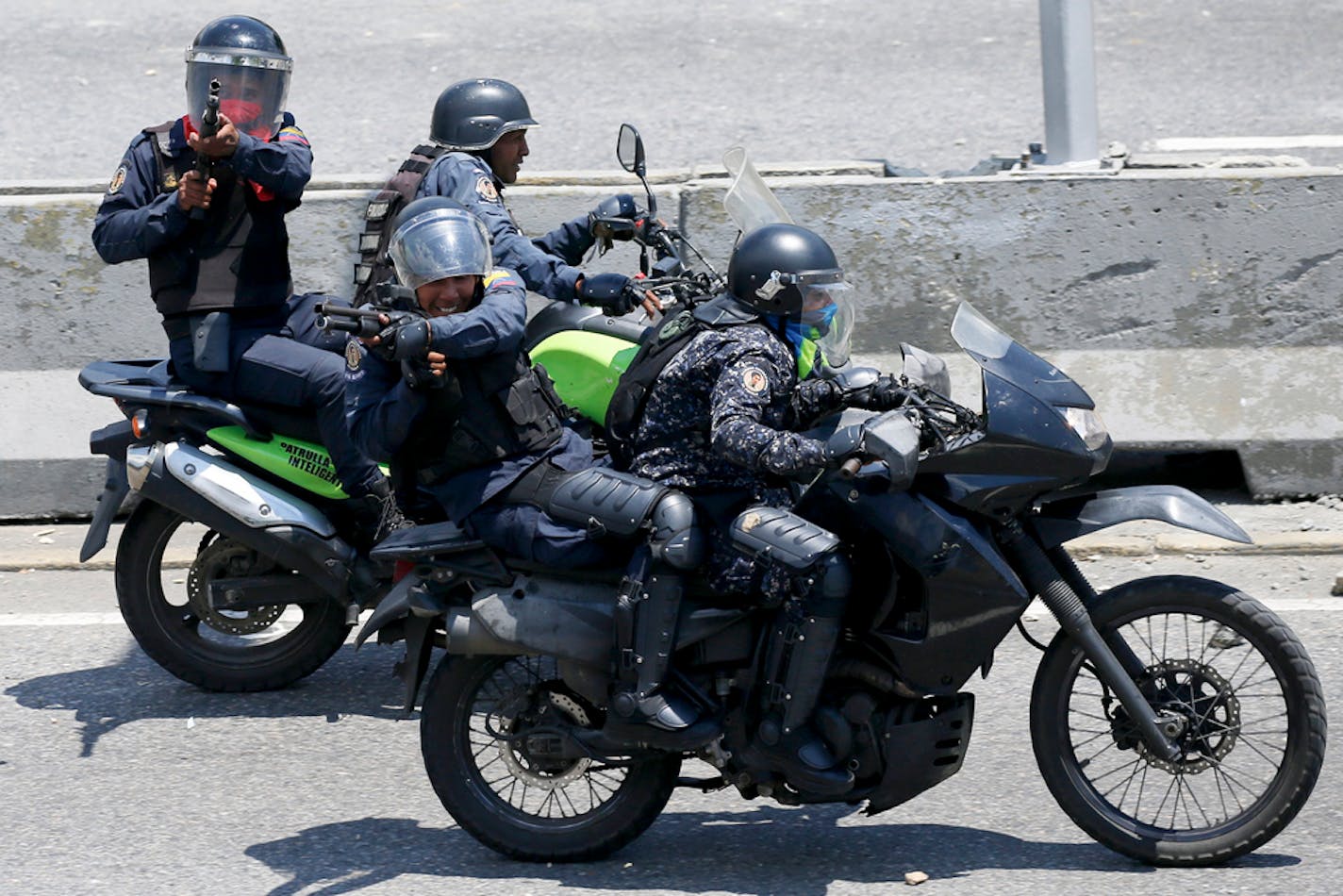 Police aim their weapons at opponents to Venezuela's President Nicolas Maduro during an attempted military uprising to oust Maduro in Caracas, Venezuela, Tuesday, April 30, 2019. Anti-government demonstrators clashed with troops loyal to Maduro hours after opposition leader Juan Guaidó took to the streets in a bold and risky attempt to lead a military uprising against the president. (AP Photo/Fernando Llano)