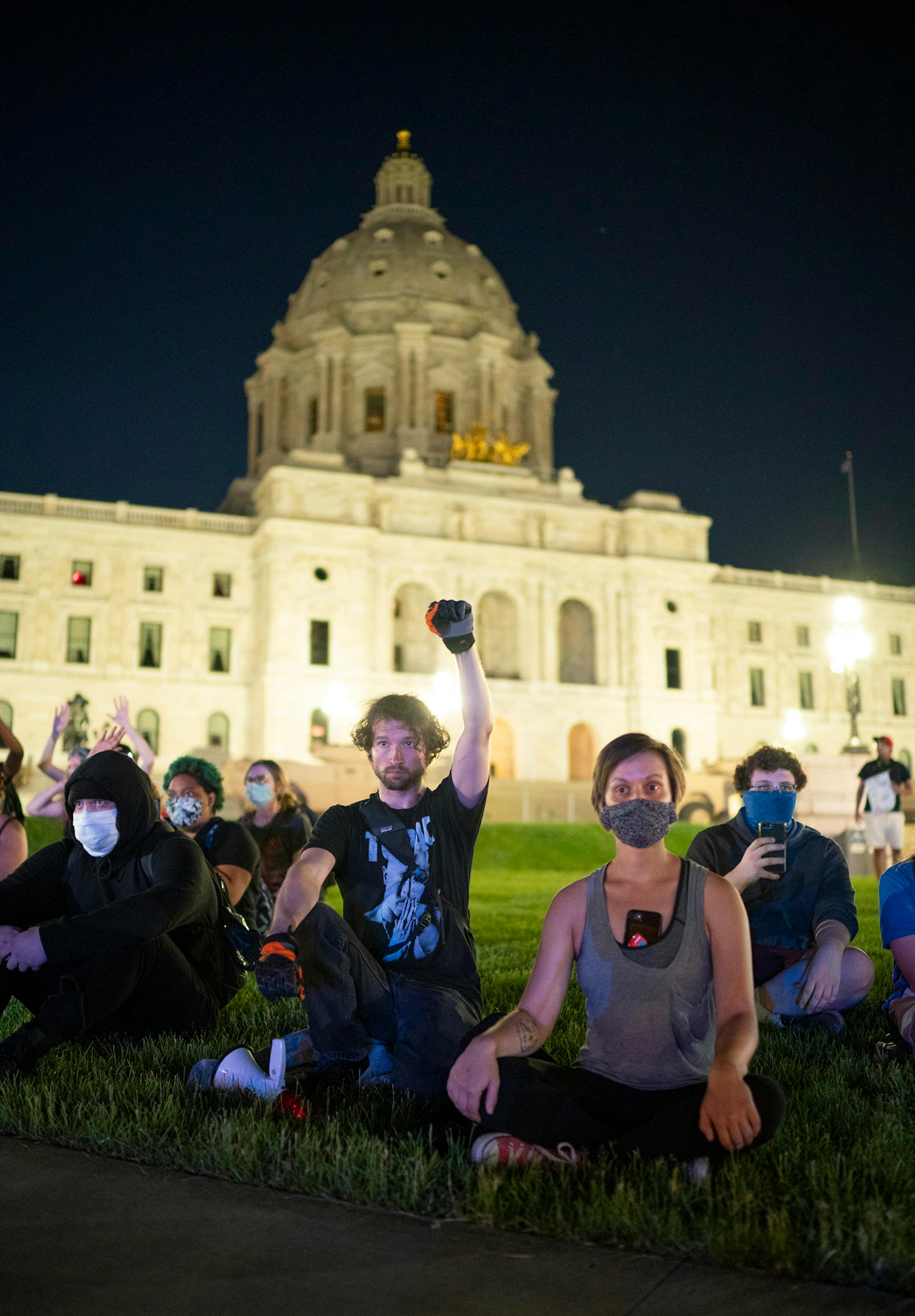 The remaining demonstrators calmly sat on the lawn of the State Capitol and waited to be arrested at 10 p.m.