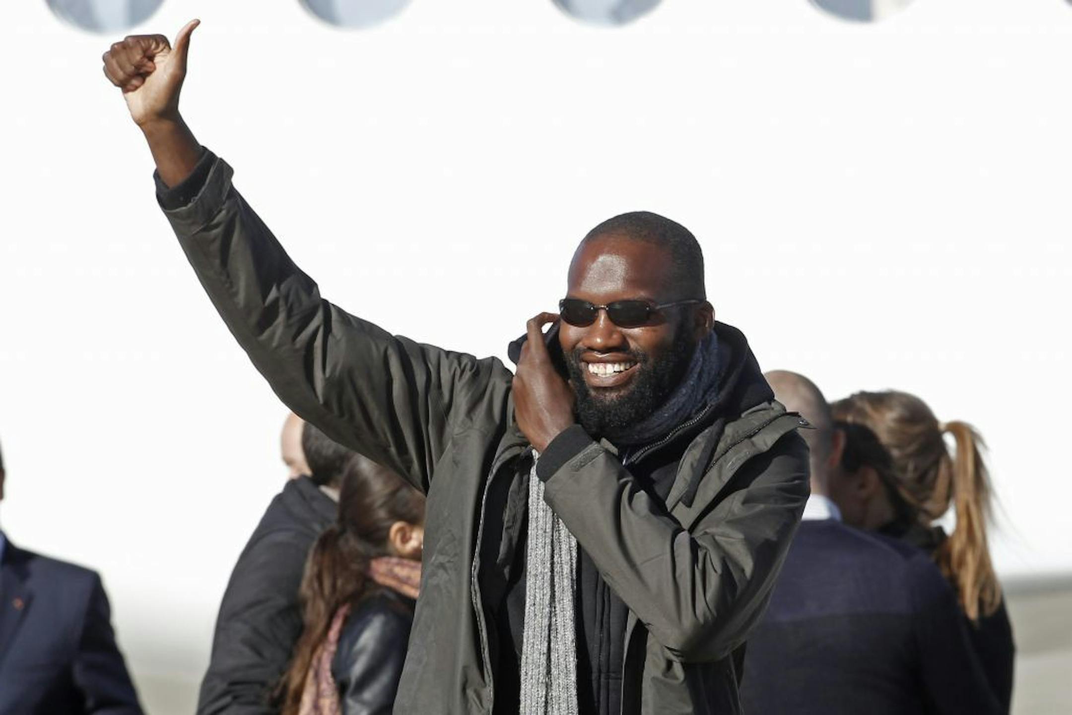 Released French hostage Thierry Dol gestures as he arrives at the Villacoublay military airbase outside Paris, Wednesday, Oct. 30, 2013.