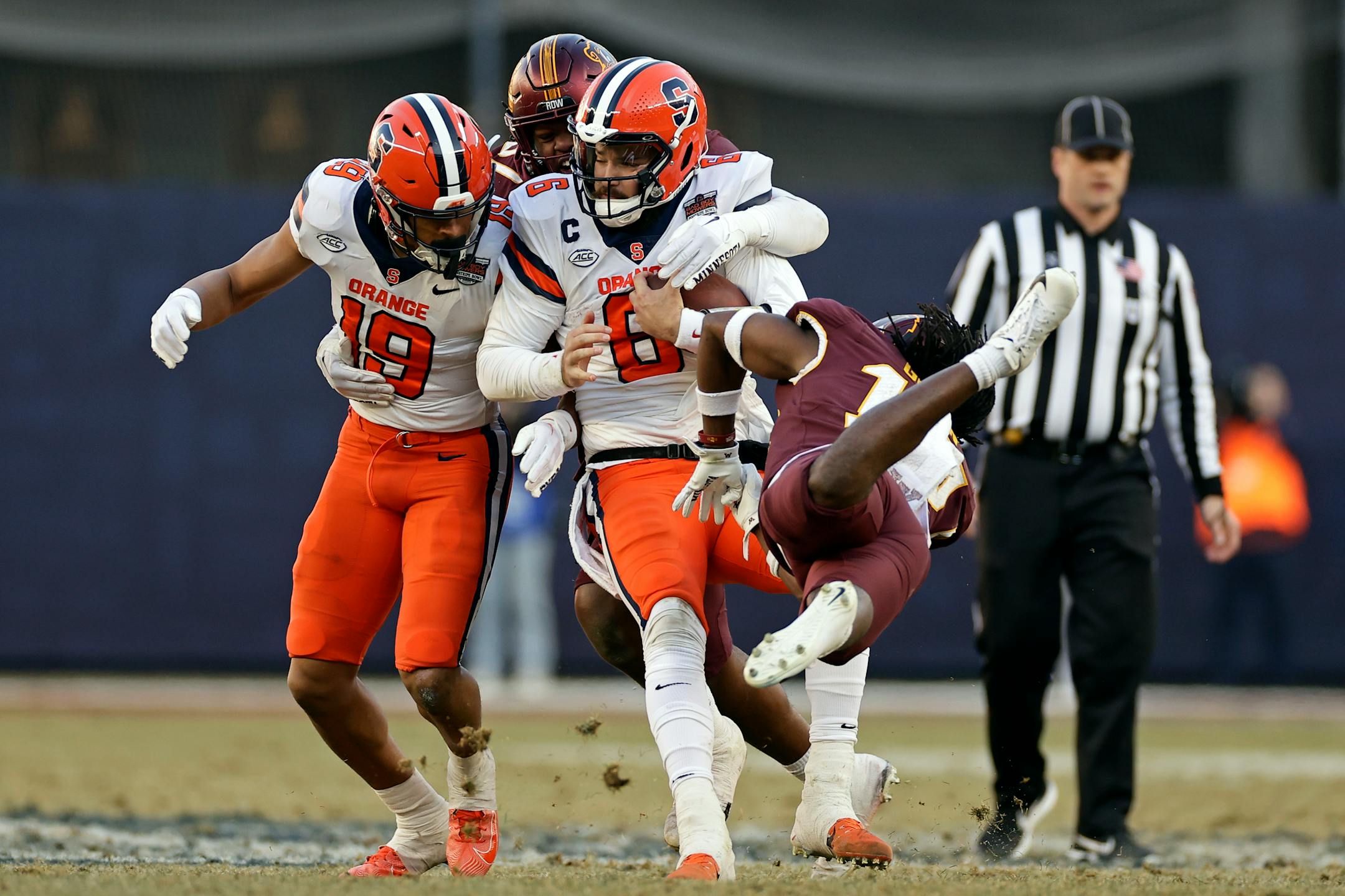 Syracuse quarterback Garrett Shrader is tackled by Minnesota defensive lineman Jalen Logan-Redding during the first half.