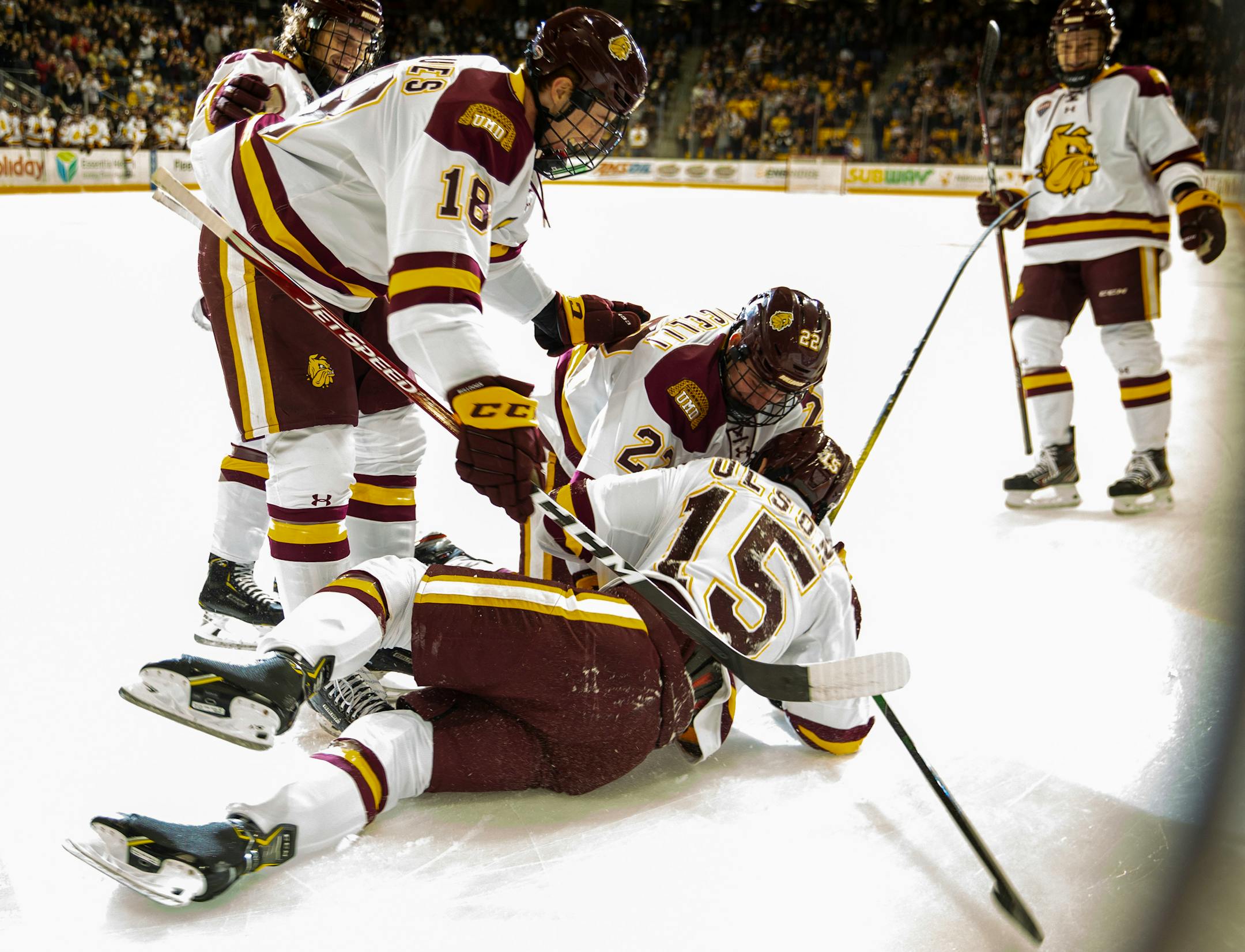 UMD players swarmed freshman forward Quinn Olson (15) after he scored his first career goal to give the Bulldogs a 1-0 lead in the first period.